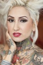 Portrait of blond woman with tattoos