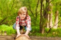 Portrait of blond young boy standing on a log Royalty Free Stock Photo