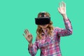 Portrait of a blond young woman enjoying vr experience with her hands up. Royalty Free Stock Photo