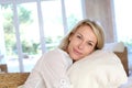 Portrait of blond young woman in white clothes relaxing at home Royalty Free Stock Photo