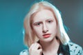 Portrait of blonde albino girl in studio