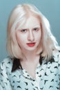 Portrait of blonde albino girl in studio