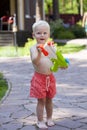 Portrait of blonde baby boy playing with water toy Royalty Free Stock Photo