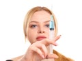 Portrait of a blonde woman isolated on white background, with a syringe in her hands, concept of medicine, plastic