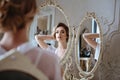 Portrait of blonde bride woman in a white lingerie sitting near mirror, fashion beauty portrait Royalty Free Stock Photo