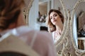 Portrait of blonde bride woman in a white lingerie sitting near mirror, fashion beauty portrait Royalty Free Stock Photo