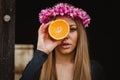 Portrait of a blonde girl with a pink wreath of flowers on her h Royalty Free Stock Photo