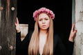 Portrait of a blonde girl with a pink wreath of flowers on her h Royalty Free Stock Photo