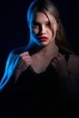 Portrait of a beautiful girl with red lips on a blue background Royalty Free Stock Photo