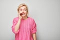 Portrait of blonde girl shouting loudly with hands, news, palms folded like megaphone Royalty Free Stock Photo