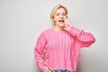 Portrait of blonde girl shouting loudly with hands, news, palms folded like megaphone Royalty Free Stock Photo