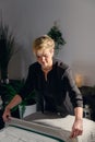 woman owner of a beauty salon, concentrated and professional, delicately covering the massage table with towels.