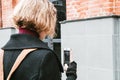 Portrait of Blonde kinky girl taking pictures of Windows on mobile device