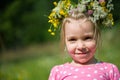 Blonde little girl with a wreath of flowers on her head Royalty Free Stock Photo