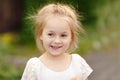 Portrait of blonde little girl of 5 years in a white dress, clos Royalty Free Stock Photo