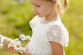 Portrait of blonde little girl of 5 years in a white dress and a Royalty Free Stock Photo