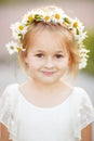 Portrait of blonde little girl of 5 years in a white dress and a Royalty Free Stock Photo