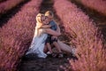 Portrait mother with little son are sitting in purple lavender field. Concept of allergy, travel