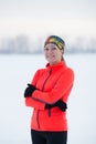 Portrait of a blonde smiling young female sportswoman in winter ice field