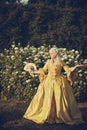 Portrait of blonde woman dressed in historical Baroque clothes with old fashion hairstyle, outdoors Royalty Free Stock Photo