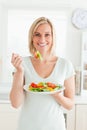 Portrait of a blonde woman eating mixed salad Royalty Free Stock Photo