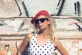 Portrait of blonde woman with polka dress and red hat