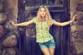 Portrait of Blonde Woman at the Wooden Door Royalty Free Stock Photo