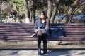 Portrait of blonde young schoolgirl sitting on the bench Royalty Free Stock Photo