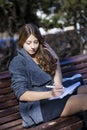 Portrait of blonde young schoolgirl sitting on the bench Royalty Free Stock Photo