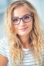 Portrait of blonde young woman with glasses