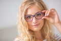 Portrait of blonde young woman in glasses Royalty Free Stock Photo