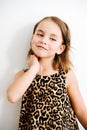 Portrait of a blue-eyed baby girl in a leopard print dress Royalty Free Stock Photo