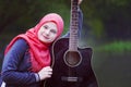 Portrait of blue eyed muslim girl holding guitar Royalty Free Stock Photo