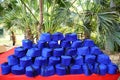 Portrait of blue turkish fez caps with black tassel placed on a table with trees or backyard in background, outdoor