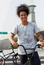Portrait, bmx and man with bicycle in city, outdoor and training in street. Cycling, funny or person laugh with bike to Royalty Free Stock Photo