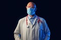 Portrait of a bold male doctor on a dark background. Man in his 40s,