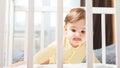 Portrait of a bored child sitting in a crib in a nursery