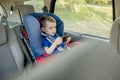 Portrait of a bored little boy sitting in a car seat. Safety of transportation of children Royalty Free Stock Photo