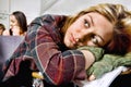 Portrait of bored Student Laying Head Down on Textbook During Class