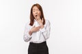 Portrait of bored or tired office lady, asian businesswoman in white shirt and black skirt, cover opened mouth as Royalty Free Stock Photo