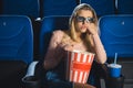 portrait of bored woman in 3d glasses with popcorn watching film alone Royalty Free Stock Photo