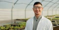 Portrait, botanist and happy man at greenhouse for science farm organic vegetables, plant or growth for ecology. Face Royalty Free Stock Photo