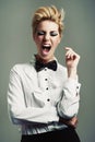 Portrait, bow tie or crazy woman with fashion, vintage clothes and classy aesthetic on grey background. Screaming, edgy Royalty Free Stock Photo