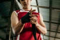 portrait of boxer fighter applying bondage tape on hands Royalty Free Stock Photo