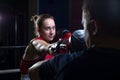 Portrait of a boxing trainer guy training a young athlete training her in martial arts. In a boxing club. Girls learn self-defense Royalty Free Stock Photo