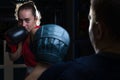 Portrait of a boxing trainer guy training a young athlete training her in martial arts. In a boxing club. Girls learn self-defense Royalty Free Stock Photo