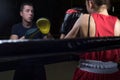 Portrait of a boxing trainer guy training a young athlete training her in martial arts. In a boxing club. Girls learn self-defense Royalty Free Stock Photo