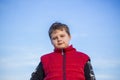 Portrait of a boy against a blue sky. Sight from below Royalty Free Stock Photo
