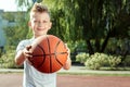 Portrait of a boy with a basketball on a basketball court. The concept of a sports lifestyle, training, sport, leisure, vacation Royalty Free Stock Photo