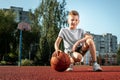 Portrait of a boy with a basketball on a basketball court. The concept of a sports lifestyle, training, sport, leisure, vacation Royalty Free Stock Photo